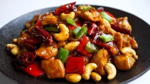 Kung Pao chicken stir-fry with tender chicken, peanuts, chili peppers, and vegetables in a glossy sauce