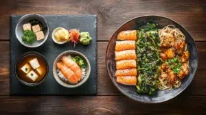 japanese vs chinese food split comparison with miso soup nigiri karaage on left and stir fry noodles dumplings on right on dark wooden table