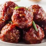 Korean gochujang meatballs glazed in spicy sweet sauce and garnished with sesame seeds and green onions