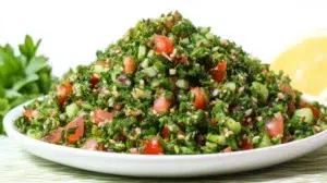 Tabbouleh salad with parsley, tomatoes, bulgur, and lemon dressing served fresh in a bowl