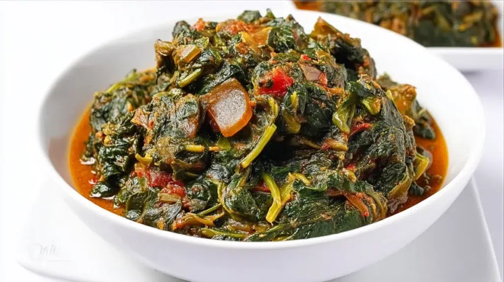 Hearty African spinach stew simmered with spinach, tomatoes, peppers, and tender meat in a rich savory sauce.
