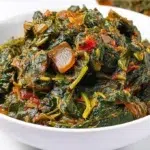 Hearty African spinach stew simmered with spinach, tomatoes, peppers, and tender meat in a rich savory sauce.