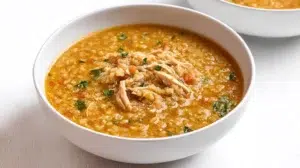 Warm freekeh soup served in a bowl, made with cracked green wheat, vegetables, and aromatic herbs.