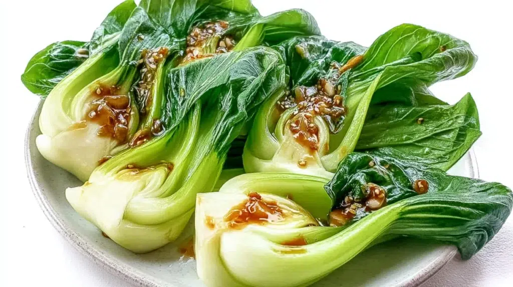 Garlic bok choy sautéed with fresh garlic until tender-crisp and lightly glazed, served as a simple side dish.