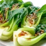 Garlic bok choy sautéed with fresh garlic until tender-crisp and lightly glazed, served as a simple side dish.