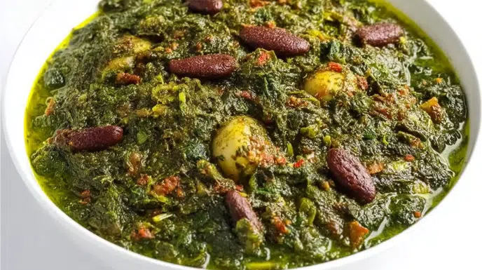 Ghormeh Sabzi herb stew simmered with fresh herbs, tender beef, kidney beans, and dried limes in a rich broth.