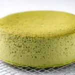 Japanese matcha souffle cheesecake with a light, airy texture, dusted with matcha powder and sliced for serving.