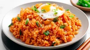 Korean kimchi fried rice stir-fried with kimchi, rice, vegetables, and topped with a fried egg.
