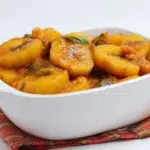 Matoke steamed plantain stew cooked with tender plantains, vegetables, and savory seasonings in a rich sauce.