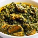Traditional Ofe Onugbu soup served in a bowl with bitter leaf, assorted meat, and rich flavorful broth.