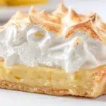 South African lemon meringue tart topped with fluffy golden meringue and filled with a smooth tangy lemon filling.