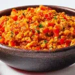 Turkish menemen made with eggs, tomatoes, peppers, and herbs, served warm in a traditional skillet.