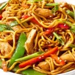 Chicken lo mein stir-fried with tender chicken, noodles, and colorful vegetables in a savory sauce.