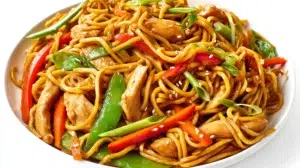 Chicken lo mein stir-fried with tender chicken, noodles, and colorful vegetables in a savory sauce.