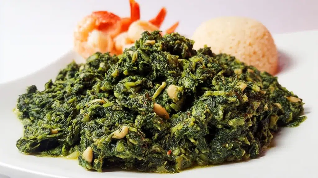 Traditional Ndole served in a bowl, featuring bitter greens, peanuts, and tender meat in a rich savory sauce.