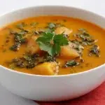 Cocoyam soup made with tender cocoyam, leafy greens, and a rich, flavorful broth, served hot in a bowl.