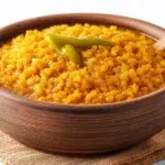Ethiopian Kik Alicha made with tender yellow split peas simmered in a mild turmeric-spiced sauce and garnished with fresh herbs.