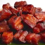 Filipino pork tocino made with tender caramelized pork slices glazed with a sweet and savory marinade, served with steamed rice.