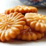 Korean honey cookies with a golden crisp exterior coated in sweet honey syrup and sesame seeds