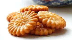 Korean honey cookies with a golden crisp exterior coated in sweet honey syrup and sesame seeds