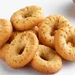 Lebanese kaak anise cookies baked until golden, featuring a crisp texture and a sprinkle of sesame seeds.