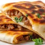 Lebanese arayes with crispy pita bread stuffed with seasoned ground meat and grilled until golden