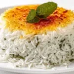 Persian rice with tahdig featuring fluffy saffron rice and a crispy golden crust served on a platter
