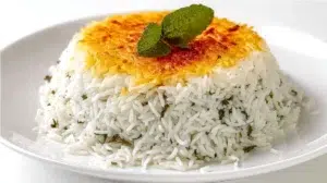 Persian rice with tahdig featuring fluffy saffron rice and a crispy golden crust served on a platter