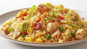 Thai pineapple chicken fried rice with tender chicken, pineapple chunks, vegetables, and jasmine rice garnished with green onions