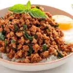 Thai basil minced pork stir-fried with garlic, chilies, and fresh Thai basil, served over steamed rice.