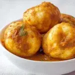 African Kuku Paka made with tender chicken simmered in a rich coconut curry sauce and garnished with fresh cilantro.