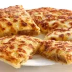 Zanzibar pizza with crispy pan-fried dough filled with seasoned meat, vegetables, egg, and melted cheese