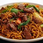 Beef pan-fried noodles with tender beef, crispy noodles, colorful vegetables, and a savory stir-fry sauce