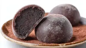 Chocolate mochi with a soft chewy texture and rich chocolate filling dusted with cocoa powder