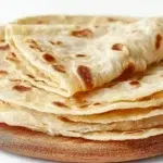 East African chapati with golden flaky layers cooked on a skillet and served warm