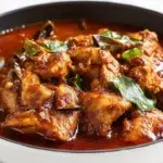 Ethiopian berbere chicken curry with tender chicken simmered in a rich spicy sauce and garnished with fresh herbs