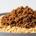 Lebanese Hashweh with seasoned ground beef, fragrant rice, toasted nuts, and warm spices served on a platter